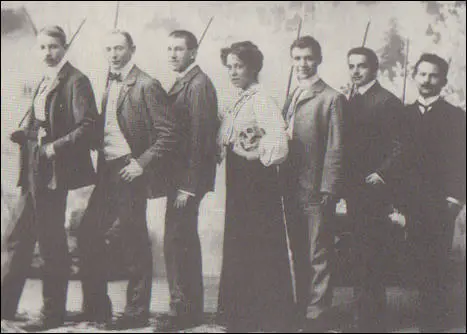 Karen Danielsen, holding skull, poses with fellow students with dueling swords (1906)
