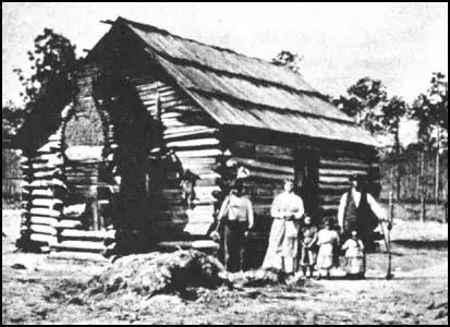 A slave family outside their cabin.