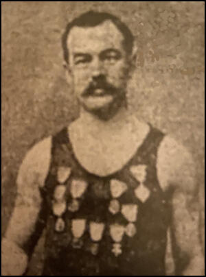 Cornelius Beal showing off his swimming medals
