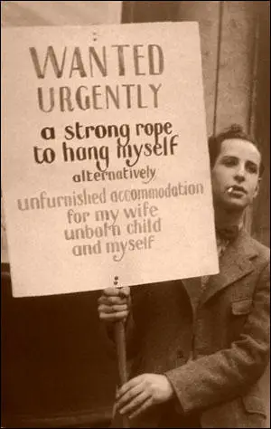 (Source 3) Photograph of unemployed man with "Wanted Urgently" placard (c. 1930)