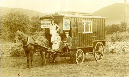 Helga Gill sitting on the caravan used by the NUWSS meetings (c. 1912)