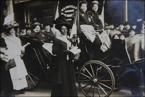 Hilda Burkitt (far left in white dress) taking part in a WSPU procession (image credit Lesley Cain, Jane Wood & Lauren Hall)