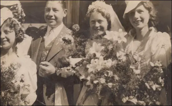 This photograph shows the happy couple with her two bridesmaids. Stella, her sister and Winnie, her future sister-in-law.