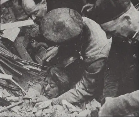 Rescue squads freeing a woman who was buried up to her neck in rubble (1941)
