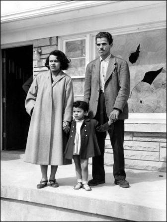 Andrew, Charlotte and Rosemary Wade stand on the front porch of their new home in Shively the day after someone hurled a a rock through the front window.