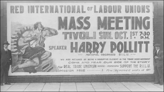Harry Pollitt, left standing beside a poster for a meeting organised by the CPGB (1922)