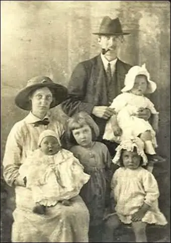 Eleven week old David Simkin in the arms of his maternal grandmotherElizabeth Hughes. Sitting alongside Mrs Hughes and Muriel's baby son is David's older brother John Simkin. This photograph was taken in the back garden of the Simkin family home at 42 Bernwell Road, Chingford, Essex in 1949.