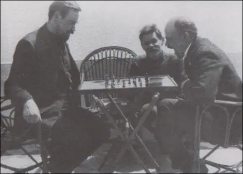 Lenin playing chess with Alexsandr Bogdanov in 1908. Maxim Gorky is seated between them.