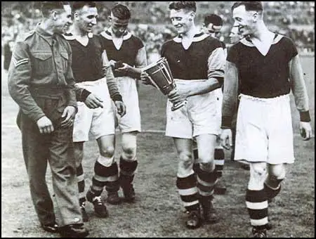 West Ham players celebrate winning the 1940 Football League Cup Final.Left to right, Corporal Norman Corbett, Ted Fenton, Charlie Bicknell,Archie Macaulay and George Foreman.