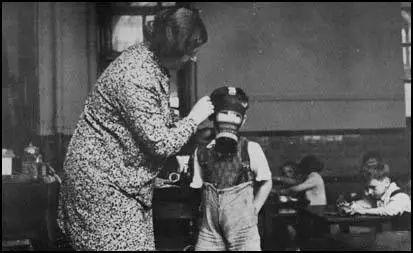 A school child tries on a gas mask in 1939.