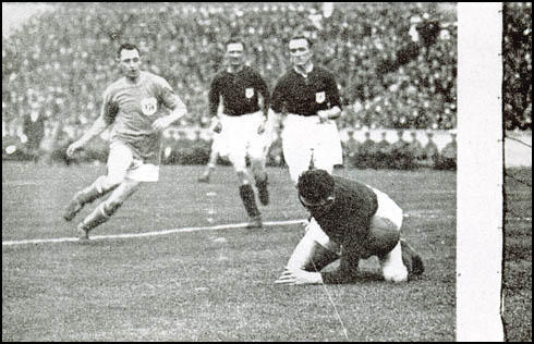 Jack Butler and Tom Parker watch Dan Lewis letting the ball slip under his body.