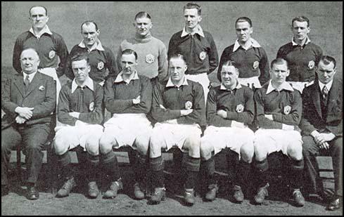 The Arsenal team in the 1932-33 season. Front (left to right): Tom Parker, Charlie Jones, Frank Moss, Herbie Roberts, Bob John and Tommy Black. Seated: Herbert Chapman, Joe Hulme, David Jack, Jack Lambert, Alex James, Cliff Bastin and Tom Whittaker.