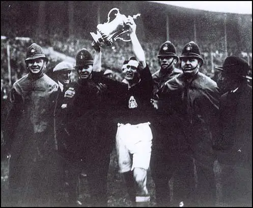 Harry Healless parades around Wembley with the FA Cup.