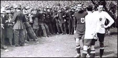David Jack, with his hand on his hip, waiting for the police to clear thecrowd from the pitch before the 1923 FA Cup Final.