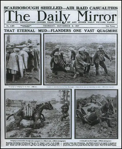 Officers walking through a flooded communication trench.