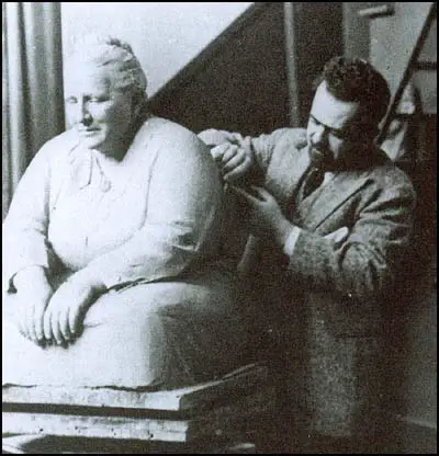 Jo Davidson woerking on a sculpture of Gertrude Stein.