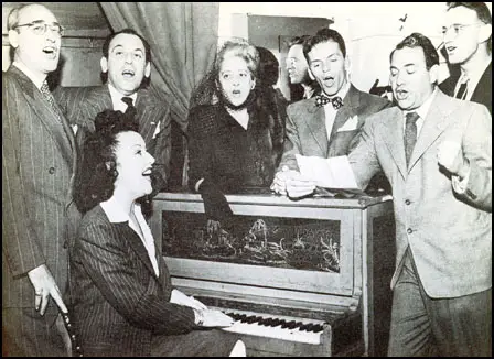Left to right: Charles Friedman, Moss Hart, Beatrice Kaufman, Frank Sinatra, Yip Harburg and Fred Saidy. Ethel Merman is at the piano.