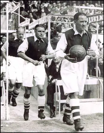 Alex James leading the Arsenal team out at a game at Highbury.