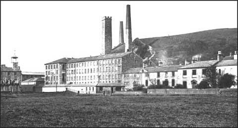 This photograph of Waterside Mill shows the original Landside cottages purchased by Joshua Fielden in 1782. The first small mill built in 1804 is next to the cottages. The building on the far right, Waterside house, was where the Fielden family. Other buildings were added over the next fifty-years. The building on the far left is the factory school built in 1827.