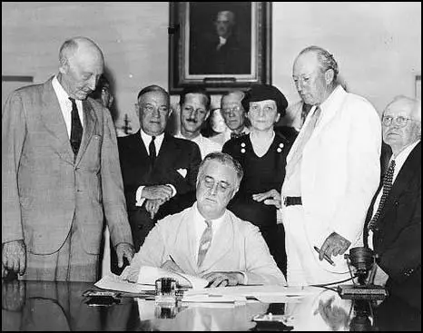 President Franklin D. Roosevelt signing the Social Security Act on 15th August, 1935. David John Lewis is on the right of the photograph.