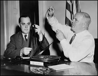 Robert E. Stripling and J. Parnell Thomas examine films to be shown to the House Un-American Activities Committee.