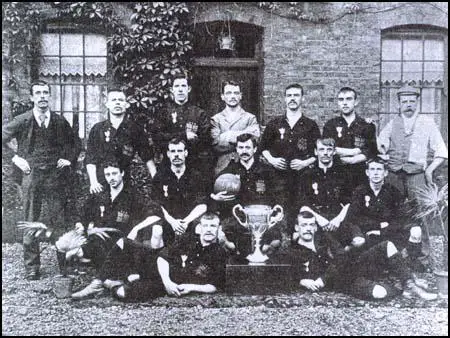 The Thames Iron Works team in 1896 with the West Ham Charity Cup. Backrow (left to right): Arnold Hills, French, Graham, Francis Payne, John Woods, Hickmanand Tom Robinson (trainer). Centre; Chamberlain, George Sage, Robert Stevenson,William Chapman, William Barnes. Front; Johnny Stewart, Thomas Freeman.