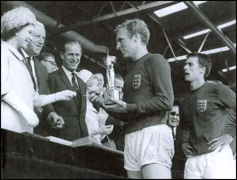 Bobby Moore receives the World Cup from the Queen in 1966.